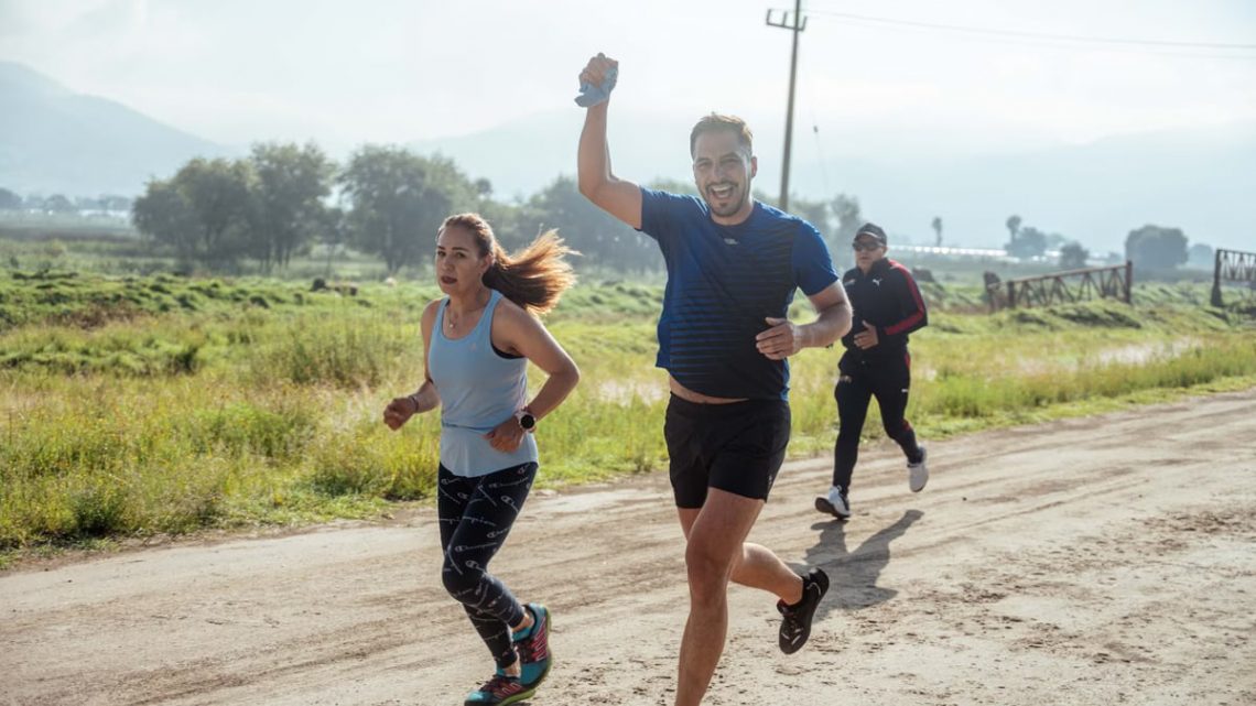 Group of people enjoying a morning run on a rural trail, embracing fitness and vitality.